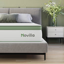 Grove Hybrid Mattress with green border and Novilla logo on a bed with grey headboard and nightstand.