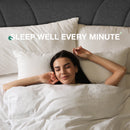 Woman sleeping peacefully on Classic Luxe dark gray upholstered bed frame with plush white bedding.