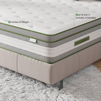 Novilla Vitality 12-inch hybrid mattress with white quilted top, grey sides, green trim, and 4 handles on a beige bed frame.